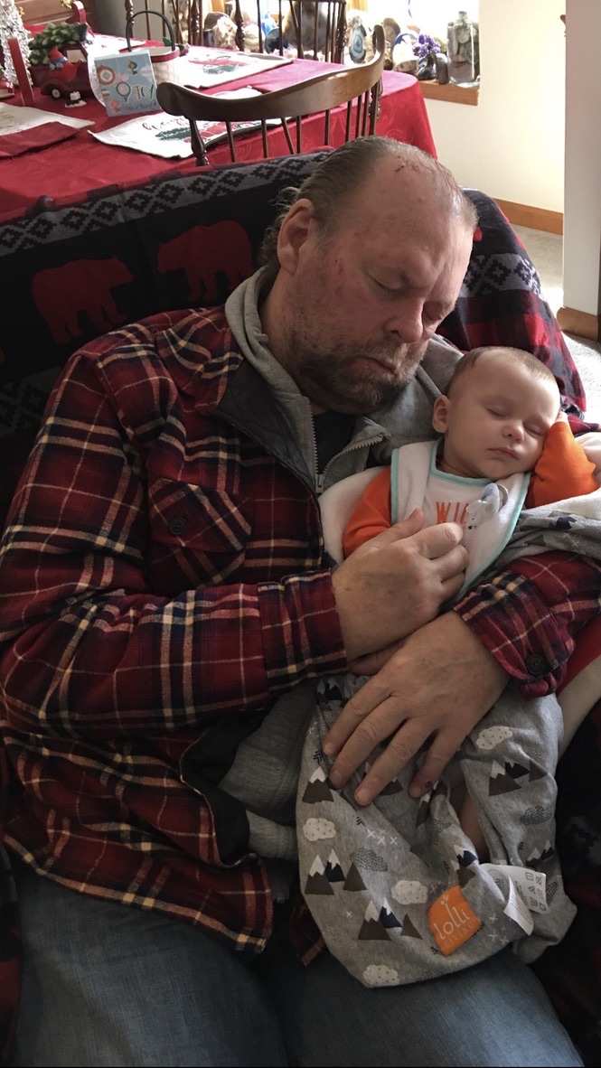 Joby Horn holding his sleeping first grandson