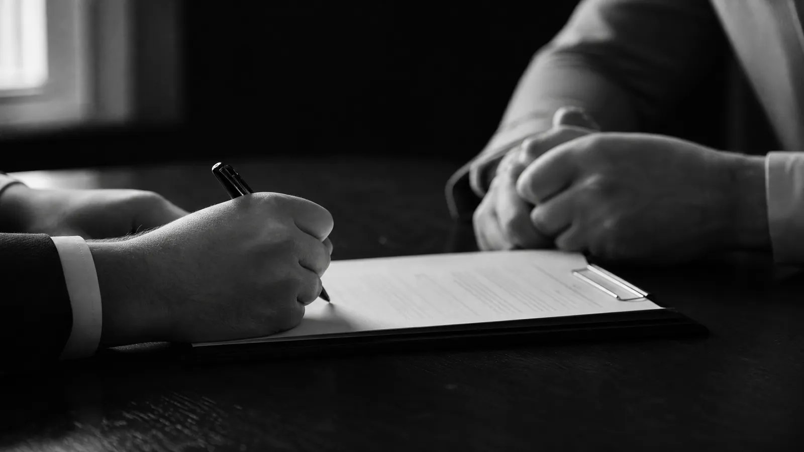 A fountain pen with its signature line cut off mid-stroke, illustrated in bone white on a dark background